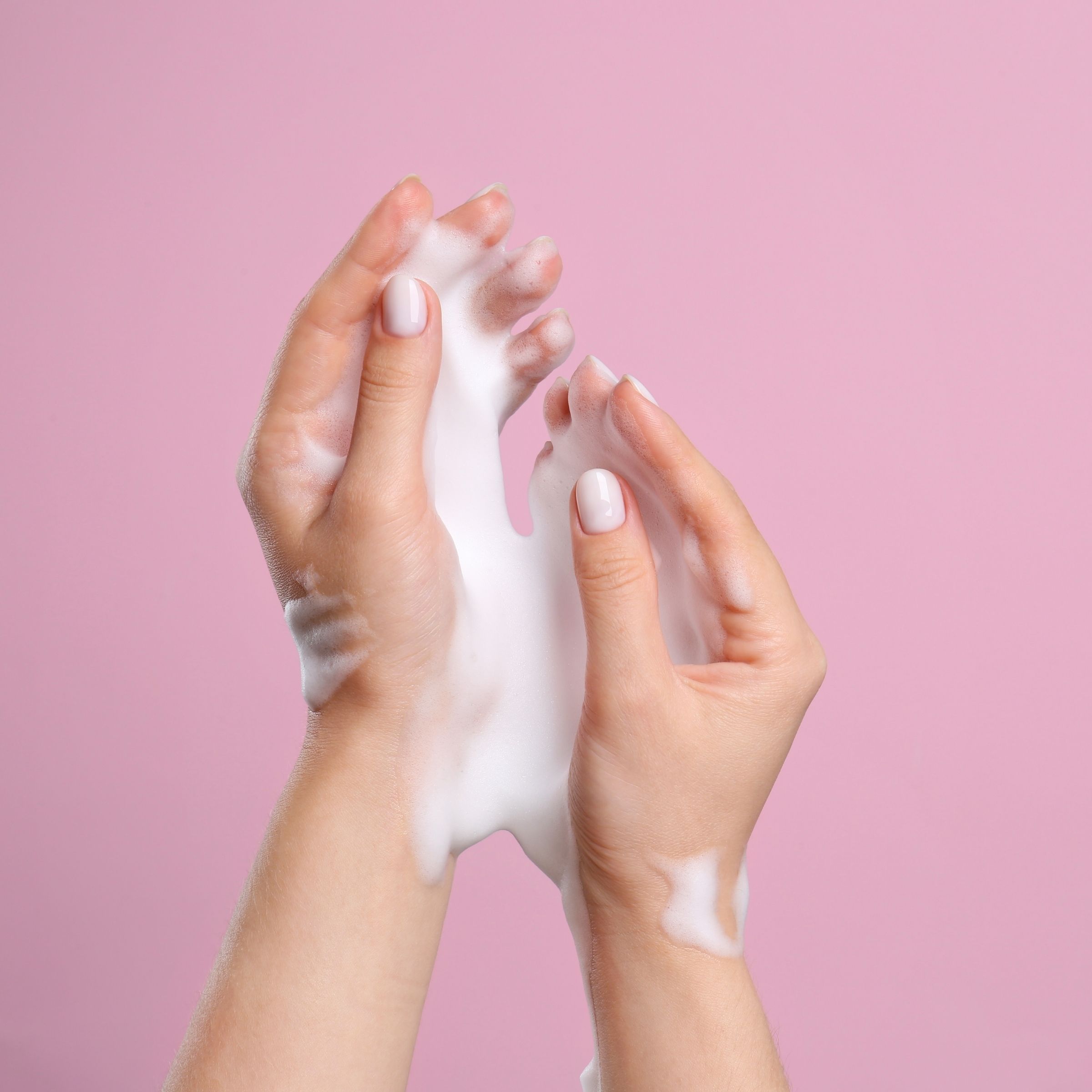 Hands lathered with soft amino acid cleansing foam